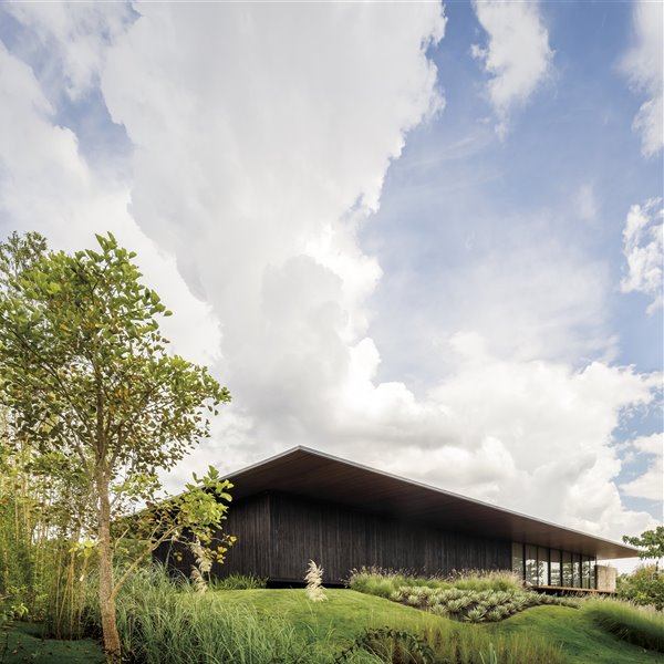 Una moderna casa de madera conectada con el paisaje brasileño que la rodea