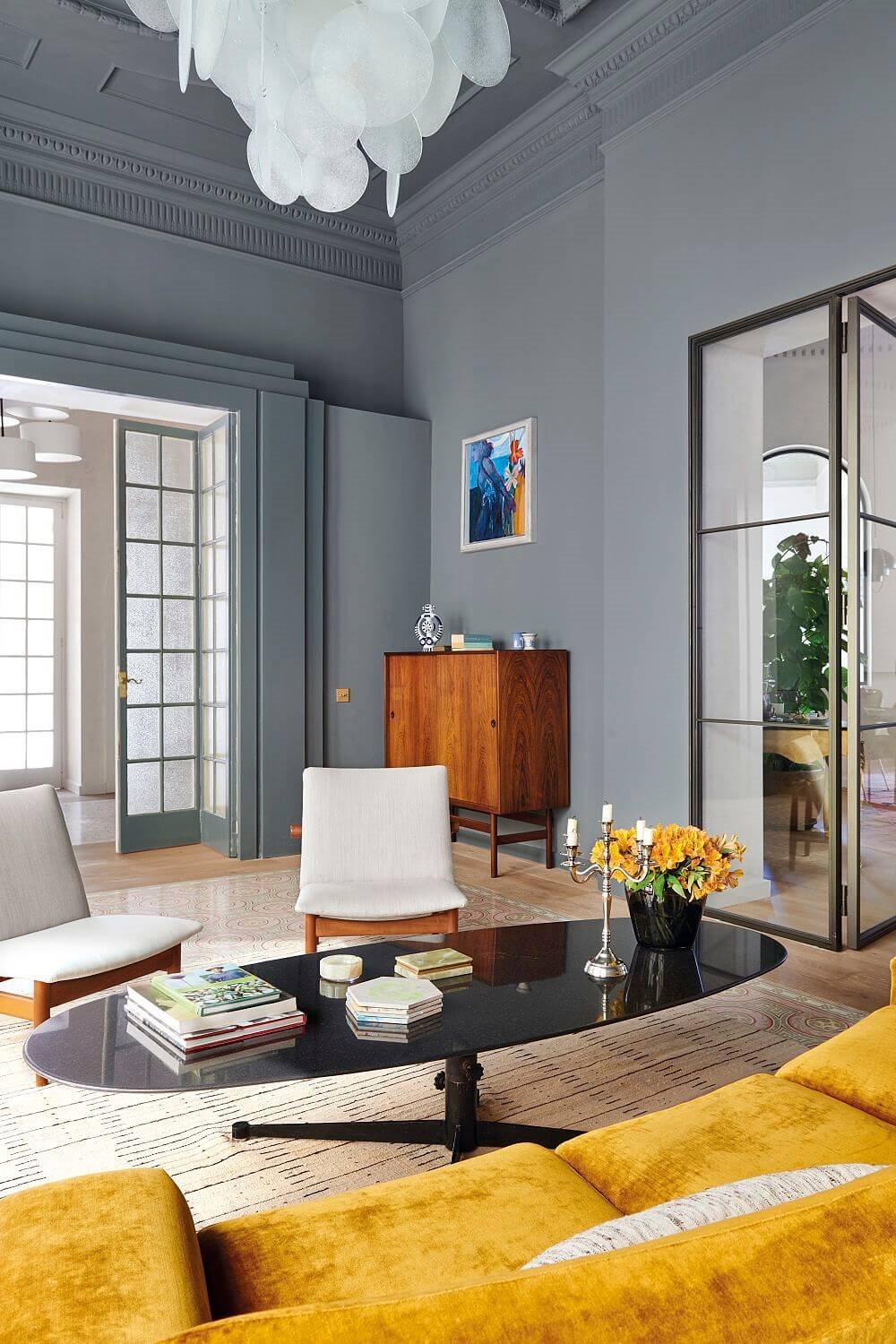 Mesa ovalada negra en salón gris