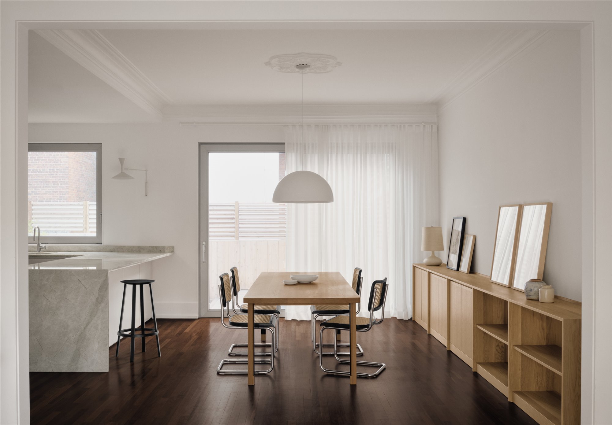 Salón con cocina integrada madera y color blanco minimalista