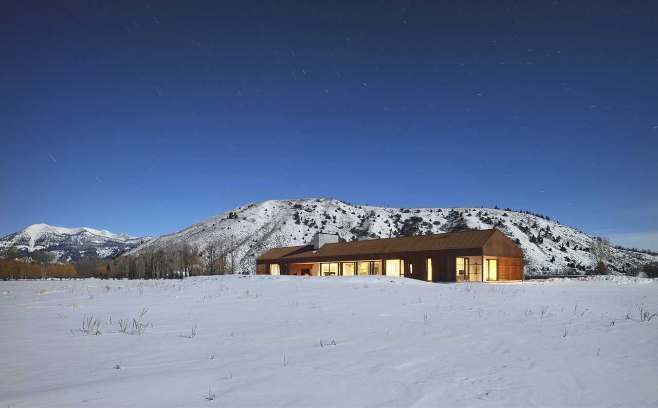 La casa se asienta en el centro de un prado y ofrece vistas panorámicas de los ranchos circundantes, las colinas y las montañas