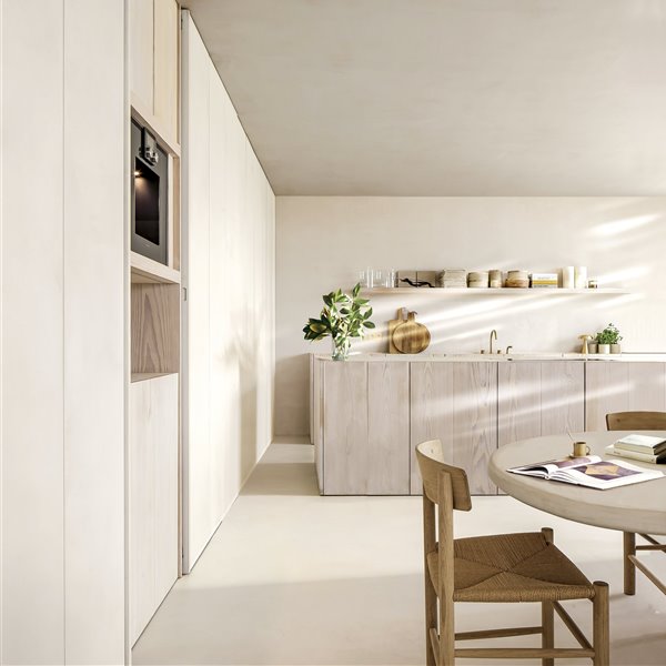 cocina beige de estudio am designs con silla de mimbre, mesa redonda y tabla de madera
