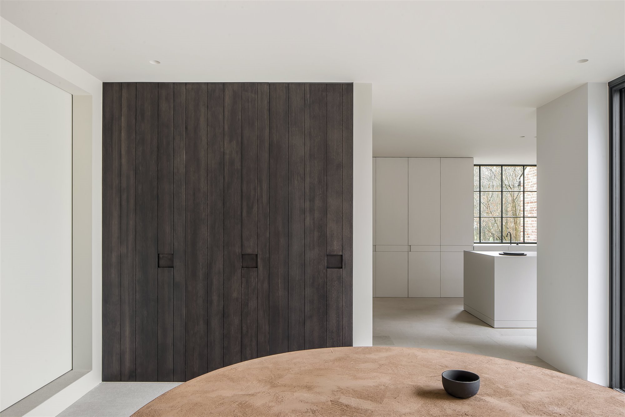 cocina blanca con armario grande de madera oscura