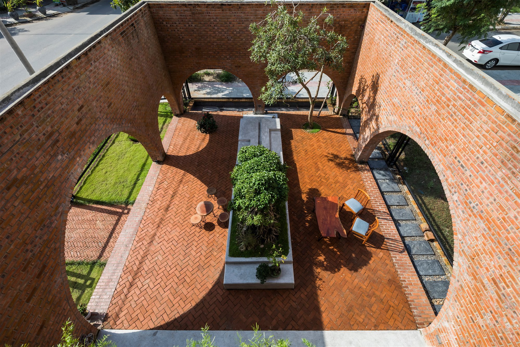 casa de ladrillos con patio lleno de plantas