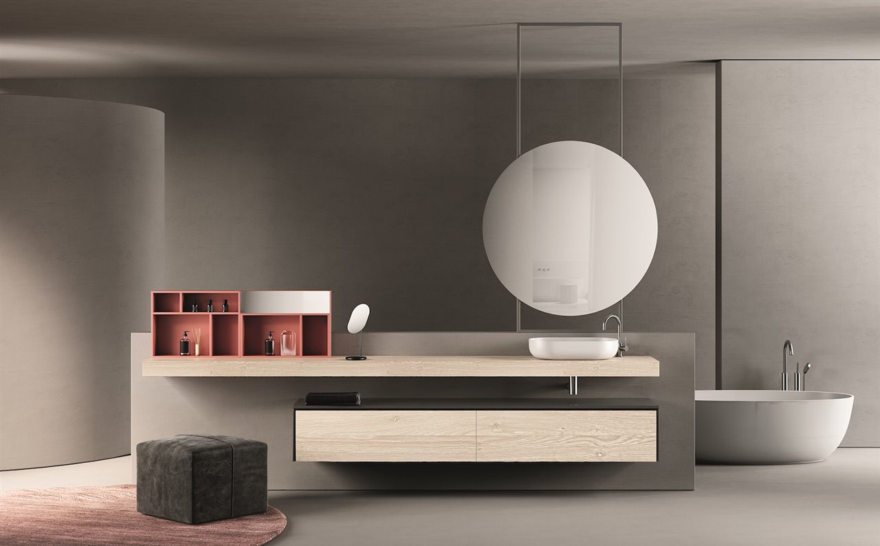 Mueble y encimera de la colección Alma con acabado roble macizo. Espejo Round Liso de estructura metálica. Bañera Leo Solid Surface.