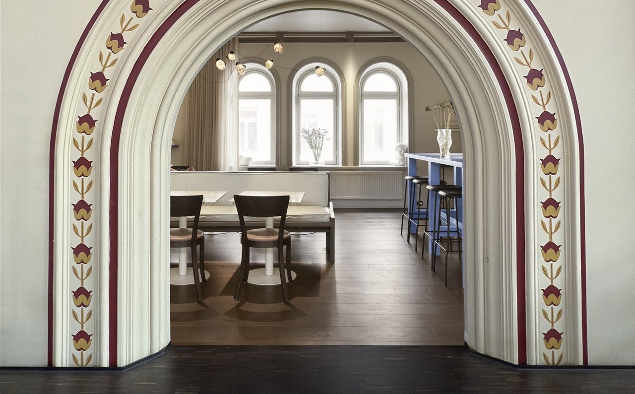 Igual que el resto de bares y puestecillos del mercado Östermalms Saluhall de Estocolmo, el restaurante Tysta Mari conserva el arco de la entrada con sus clásicos ornamentos.
