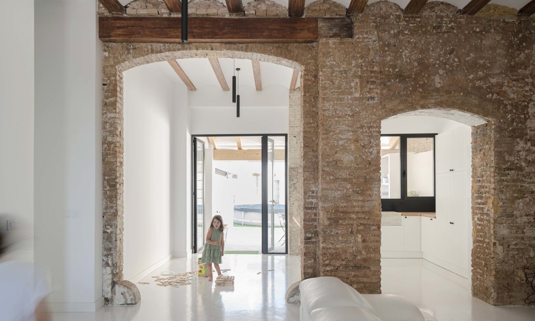 Dos arcos de piedra originales dan sentido a esta (restaurada) casa de Valencia