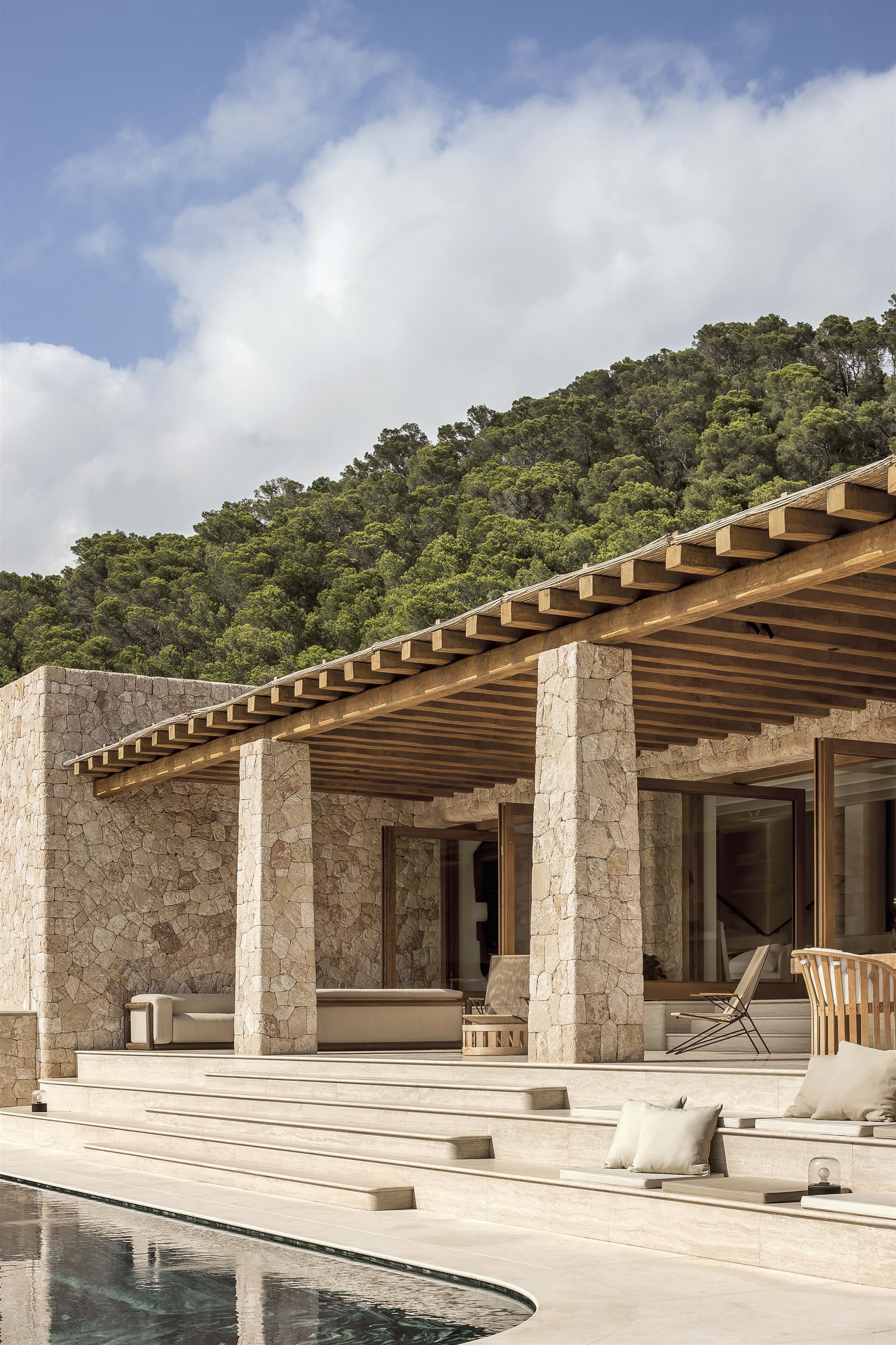 porche de piedra y madera con piscina y escaleras de mármol