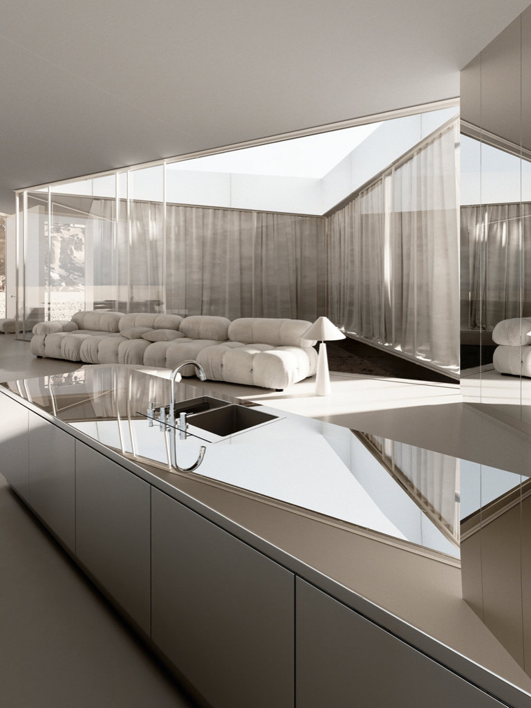 La cocina y el salón se integran en el mismo espacio. La espectacular arquitectura resalta ante la escasez de elementos decorativos.