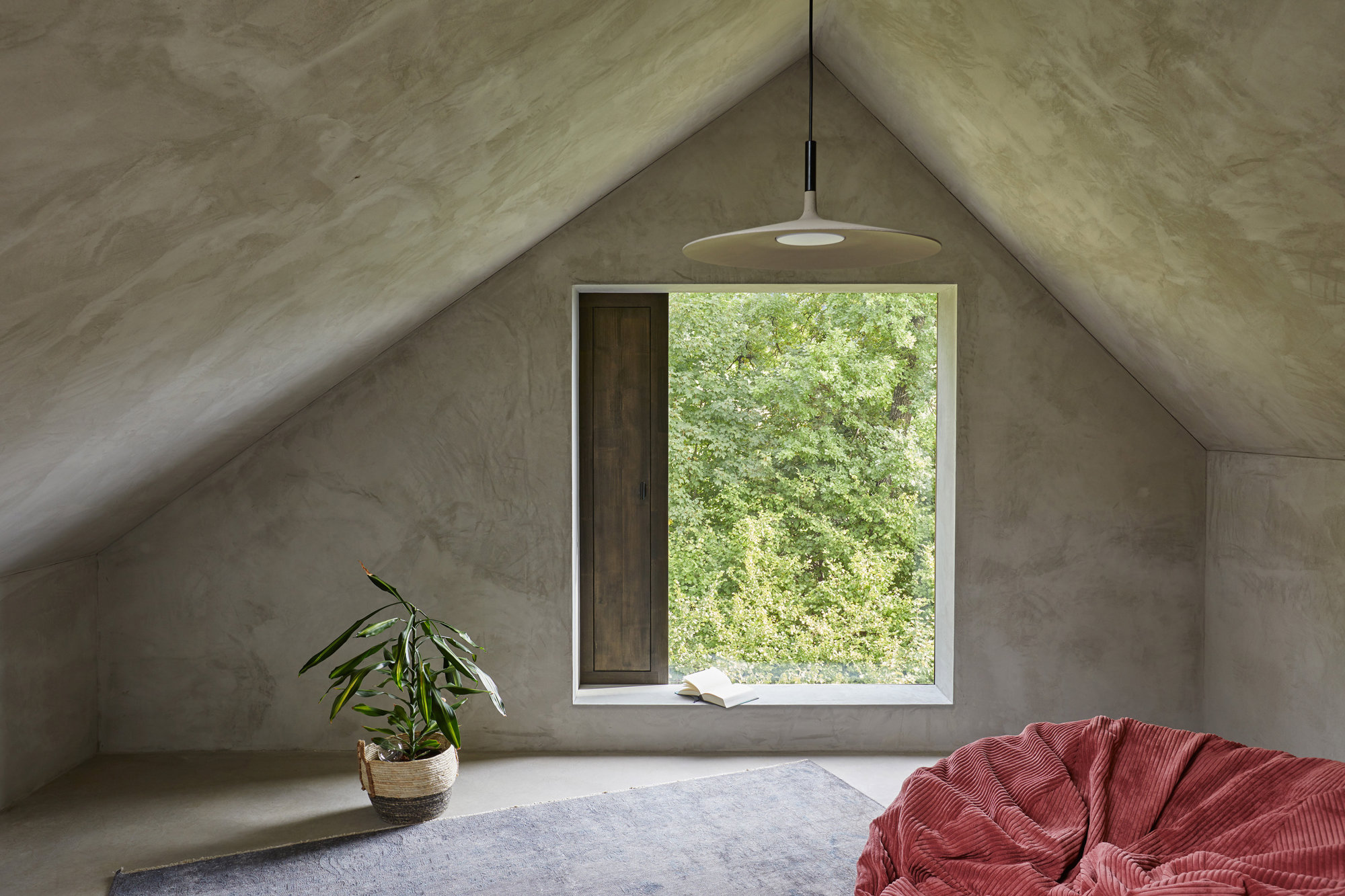 casa de estilo brutalista con ventana que da a la naturaleza